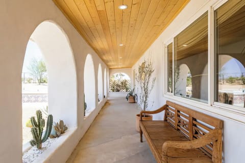 	Seven arches, a pine ceiling, and cactus beds cut into the plaster.