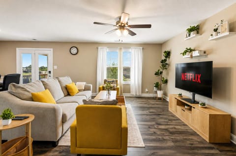 Living Room 1: A cozy living room with comfortable seating, warm decor, and plenty of natural light, creating an inviting space to relax, unwind, or spend time together.