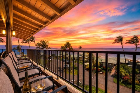 Your lanai comes alive at sunset, with lounge seating for the group and layered views of the coastline below.