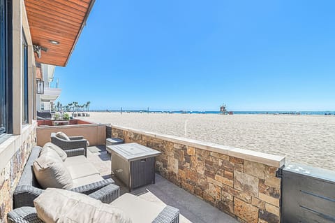 Relax on the oceanfront patio with the sand and Pacific just beyond
                