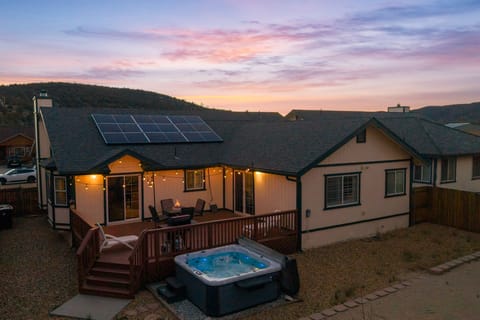 Back Deck - Private Hot Tub in backyard with string lights and gas fire pit.