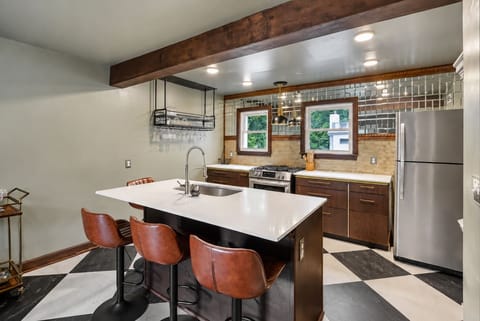 Gather around the spacious kitchen island for casual meals, drinks, or conversation.