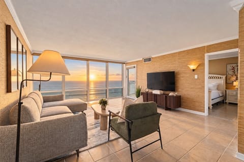 Wake up to this. Floor-to-ceiling ocean views and unforgettable sunrises fill the living room—your front-row seat to the Atlantic without ever leaving the condo.