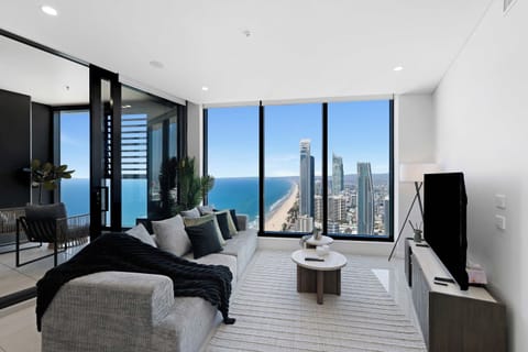 Oceanfront High-Rise Living Room
Soak in sweeping ocean horizons and skyline vistas from your plush sectional couch. Features a large flat-screen TV for cozy high-altitude movie nights.