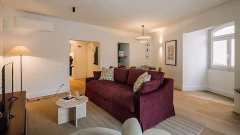 Settle into the plush sofa in this bright living area, perfect for unwinding after a day of exploring.
#LivingRoom #ComfortableStay #AndoLiving