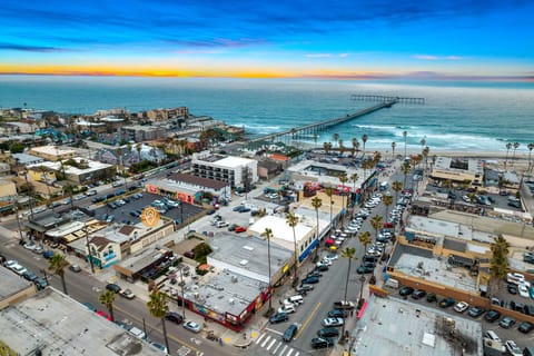 🌊 The perfect drone view of the pier and coastline—your stay puts the beach town's best backdrop right outside.