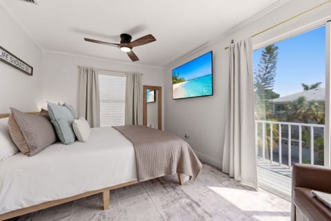 Bright, serene bedroom with private balcony and sunny outdoor views