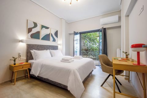 Bedroom 1 with double bed and workspace