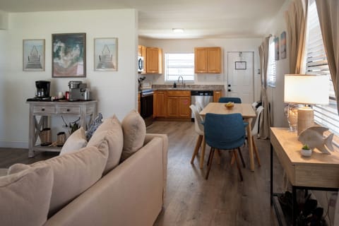 Coral House 2BR – Open living space with sofas, dining for four and full kitchen – minutes from the sand