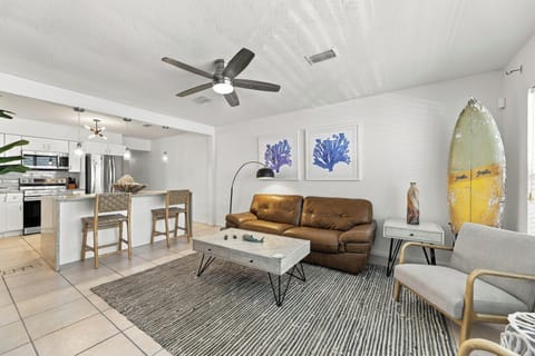 Bright coastal living room with open kitchen and stylish beach decor