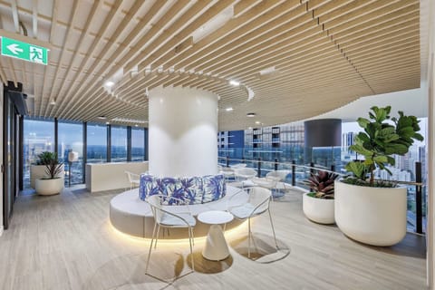 Modern High-Rise Lounge
Relax in luxury in this architectural lounge featuring sleek slatted wood ceilings and circular plush seating. The perfect indoor spot to catch up with friends alongside panoramic city views.