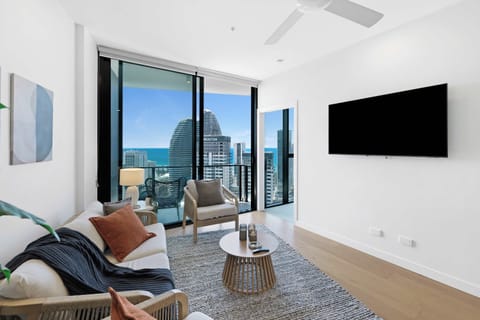 Modern Living Room with Ocean View
Relax in style with panoramic ocean and skyline views right from the sofa. Features a large wall-mounted flat-screen TV and direct access to your private balcony.