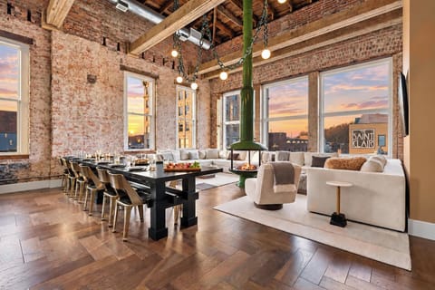 The Penthouse has an open-concept living space with dramatic architecture and skyline views
