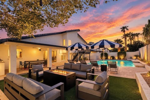 The backyard invites relaxed afternoons between the private pool and shaded loungers, followed by dinner in the covered dining area for 10 and conversation around the fire pit in the outdoor lounge area.