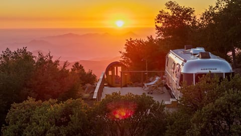 Sunset over Restore Outpost’s sauna, Airstream, and spacious deck.