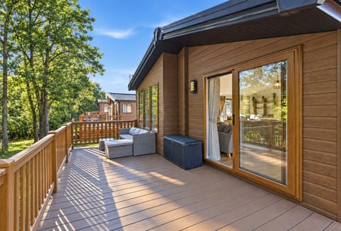 Spacious wooden deck with outdoor seating and sliding glass doors