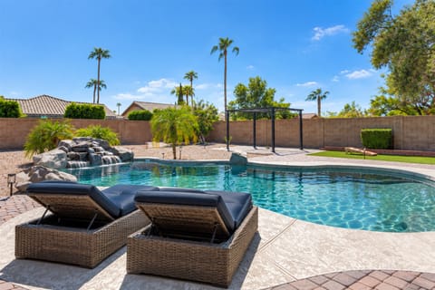 Poolside lounging with the soothing sound of a rock fountain.
