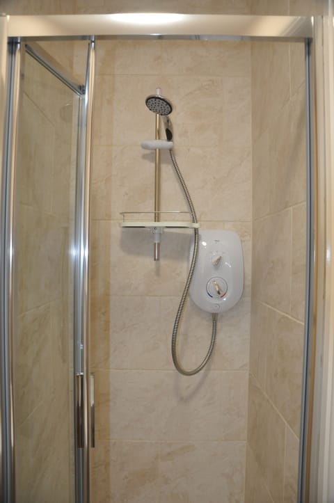 Shower, hair dryer, towels, shampoo