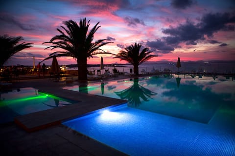 Seasonal outdoor pool, open 11:00 AM to 7:00 PM, pool umbrellas