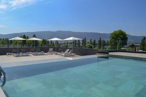 Seasonal outdoor pool, open 9 AM to 8 PM, sun loungers