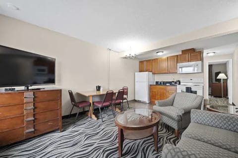 Suite, 1 Queen Bed, Kitchen | Living area | 50-inch LED TV with cable channels, TV