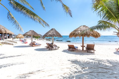 On the beach, white sand, beach umbrellas, beach towels