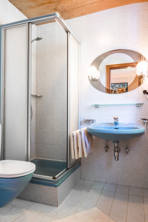 Shower, designer toiletries, hair dryer, towels