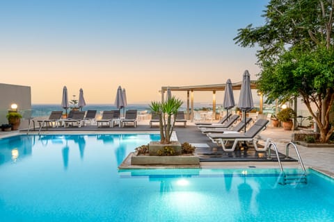 Seasonal outdoor pool, open 10:00 AM to 6:00 PM, pool umbrellas