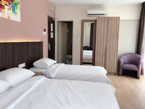 Deluxe Triple Room | Minibar, in-room safe, desk, iron/ironing board (on request)