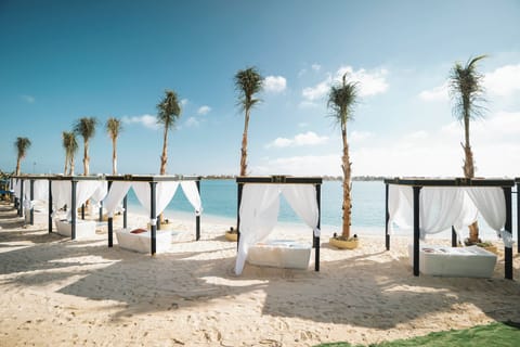 Private beach, white sand, beach umbrellas, motor boating
