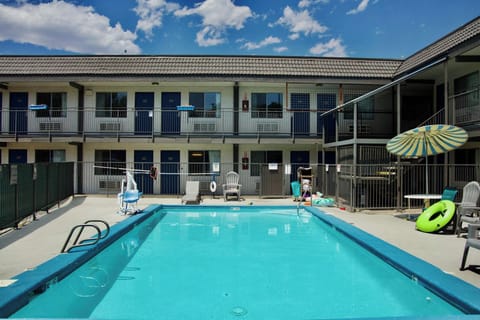 Seasonal outdoor pool, open 10:00 AM to 10:00 PM, pool umbrellas