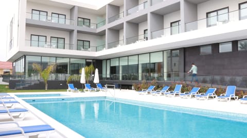 Seasonal outdoor pool, open 9:00 AM to 7:00 PM, pool umbrellas
