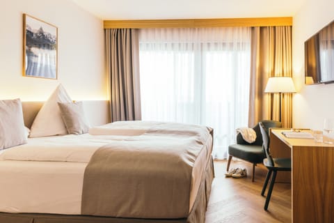 Standard Double Room | Minibar, in-room safe, desk, blackout drapes