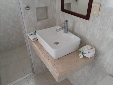 Shower, rainfall showerhead, hair dryer, towels