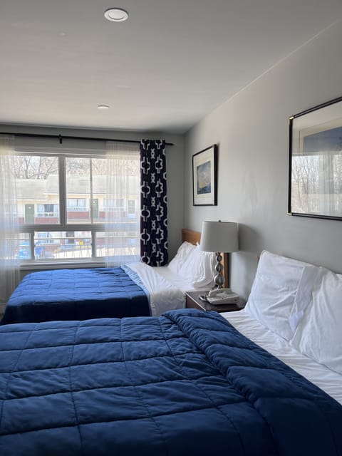 Room, 2 Queen Beds | Bathroom | Combined shower/tub, free toiletries, hair dryer, towels