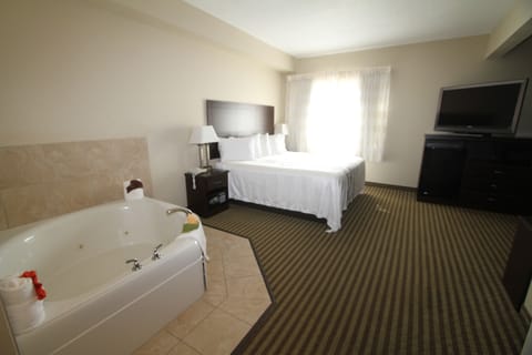 Room, 1 King Bed, Jetted Tub | Desk, laptop workspace, soundproofing, iron/ironing board