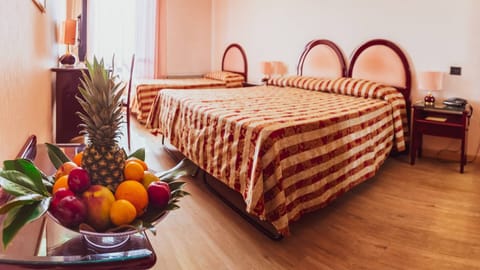 Triple Room | Minibar, in-room safe, desk, cribs/infant beds