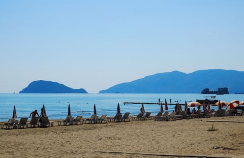 On the beach, sun loungers, beach umbrellas