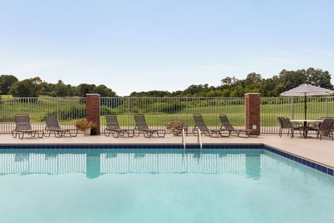 Seasonal outdoor pool, open 10:00 AM to 10:00 PM, pool umbrellas