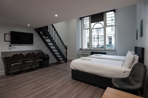 Deluxe Family Studio | Iron/ironing board, cribs (free), bed sheets