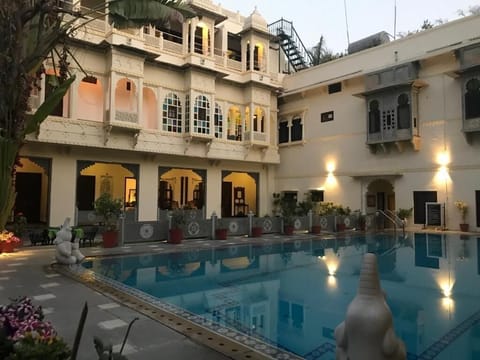 Outdoor pool, open 9:00 AM to 7:00 PM, pool umbrellas