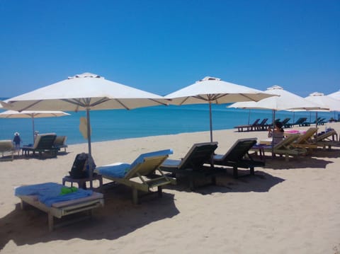 Private beach, white sand, sun loungers, beach umbrellas