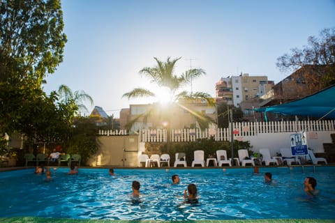Seasonal outdoor pool, open 11:00 AM to 6:00 PM, pool umbrellas