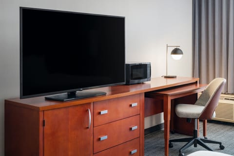 Premium bedding, desk, laptop workspace, blackout drapes