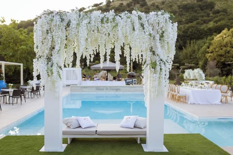 Seasonal outdoor pool, open 9:00 AM to 6:00 PM, pool umbrellas