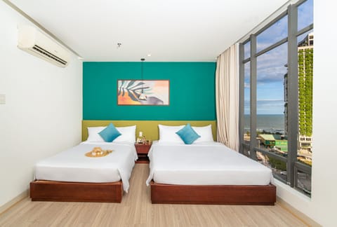 Deluxe Triple Room | Minibar, in-room safe, desk, laptop workspace