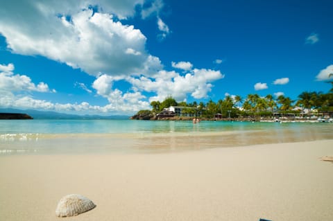 On the beach, white sand, sun loungers, beach umbrellas