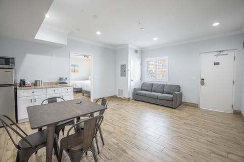 Suite, 2 Double Beds (located across the street) | Living area | 27-inch flat-screen TV with cable channels, TV