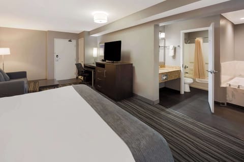 Suite, 1 King Bed, Non Smoking, Jetted Tub | Premium bedding, desk, iron/ironing board, rollaway beds