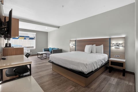 Premium bedding, desk, laptop workspace, blackout drapes